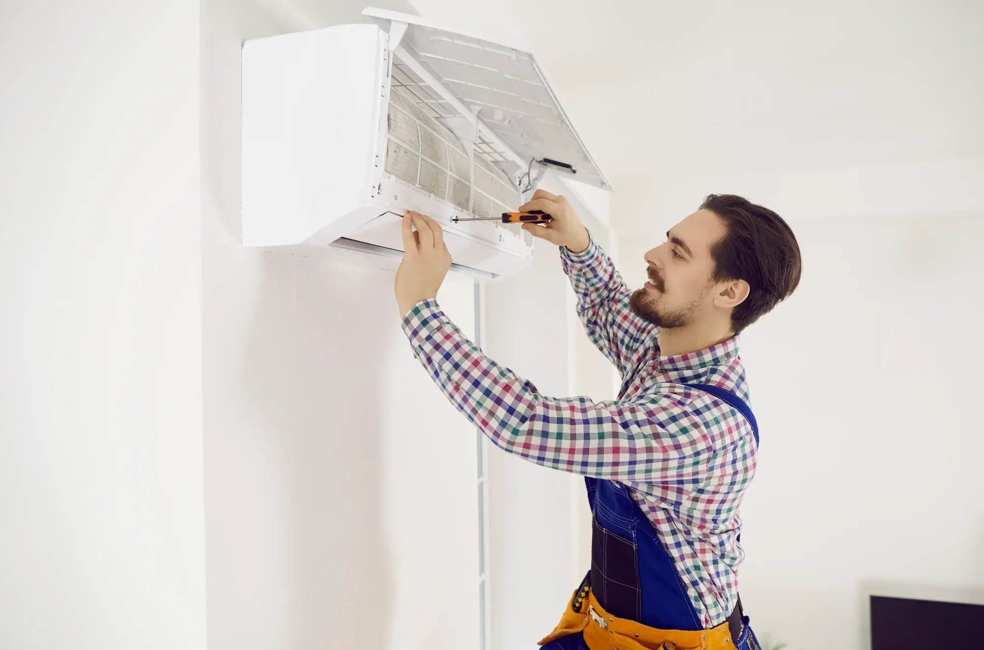 man fixing air con unit